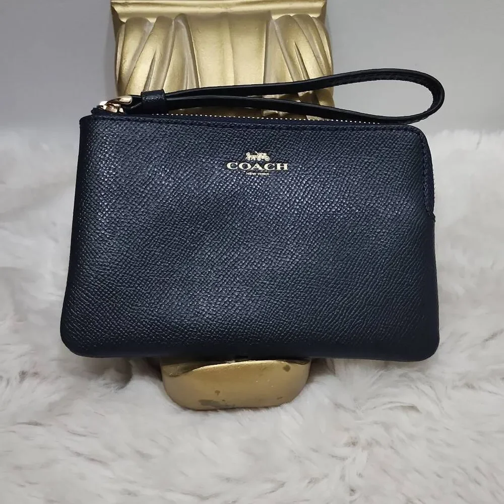 Coach Corner Zip Wristlet in crossgrain leather.